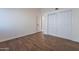 Well-lit bedroom with wood-look floors and access to hallway at 1326 E Clearwater Ln, Gilbert, AZ 85234