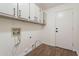 Laundry room with built-in cabinets and wood-look floors at 1326 E Clearwater Ln, Gilbert, AZ 85234