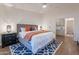 Main bedroom with gray platform bed and access to hallway at 1326 E Clearwater Ln, Gilbert, AZ 85234