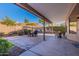 Covered patio with seating area and yellow umbrella at 1326 E Clearwater Ln, Gilbert, AZ 85234