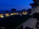Landscaped backyard with a water feature at night at 15047 S 178Th Dr, Goodyear, AZ 85338
