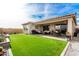 Backyard patio with seating area and artificial turf at 15047 S 178Th Dr, Goodyear, AZ 85338