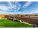 Landscaped backyard with artificial turf, water feature, and mountain views at 15047 S 178Th Dr, Goodyear, AZ 85338