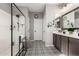 Bathroom with black framed glass shower and patterned tile floor at 15047 S 178Th Dr, Goodyear, AZ 85338