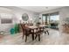 Dining room with wooden table and bench seating, and access to backyard at 15047 S 178Th Dr, Goodyear, AZ 85338