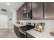 Modern kitchen features stainless steel appliances and white countertops at 15047 S 178Th Dr, Goodyear, AZ 85338