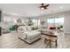 Open living area with a large sectional sofa and tile floors at 15047 S 178Th Dr, Goodyear, AZ 85338