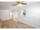 Bright living room with wood-look floors and arched entryway at 15201 N 25Th St, Phoenix, AZ 85032