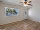 Spacious living room with wood-look floors, a ceiling fan, and a window at 15201 N 25Th St, Phoenix, AZ 85032