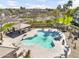 Beautiful community pool area featuring a covered pavilion, sun loungers, and tropical palm trees at 1578 S Sabino Ct, Gilbert, AZ 85296