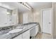 Bathroom features double sinks, granite counters, updated vanity lighting and neutral walls at 1578 S Sabino Ct, Gilbert, AZ 85296