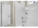 Clean and bright full bathtub with white tile walls and updated fixtures at 1578 S Sabino Ct, Gilbert, AZ 85296