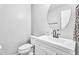 Clean, well-lit bathroom featuring a white vanity and a round mirror at 1578 S Sabino Ct, Gilbert, AZ 85296