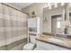 Well-maintained bathroom with granite counters, white cabinets, and a stylish shower curtain at 1578 S Sabino Ct, Gilbert, AZ 85296