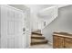 Bright entryway featuring a staircase with carpeted steps and white railings, and a white front door at 1578 S Sabino Ct, Gilbert, AZ 85296