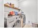 Functional laundry room with modern LG washer and dryer, complemented with ample shelving at 1578 S Sabino Ct, Gilbert, AZ 85296