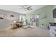 Inviting living room featuring a comfortable sofa, large windows, and a ceiling fan at 1578 S Sabino Ct, Gilbert, AZ 85296