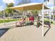 Community playground featuring colorful play structures, a covered seating area, and a safe, sandy play surface perfect for  at 1578 S Sabino Ct, Gilbert, AZ 85296