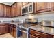 Kitchen detail showing stainless steel appliances and granite countertops at 16008 N 109Th Dr, Sun City, AZ 85351