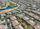 Community aerial view highlighting single Gathering homes, landscaping, golf course and community pool at 16954 W Palm Ln, Goodyear, AZ 85395