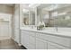 Bathroom boasts double sinks, a white vanity with modern fixtures, and well lit mirrors at 16954 W Palm Ln, Goodyear, AZ 85395