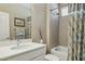 Well-lit bathroom featuring a shower-over-tub, modern vanity, large mirror, and neutral color palette at 16954 W Palm Ln, Goodyear, AZ 85395