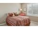 Inviting bedroom featuring Southwestern themed bedding and decor, a window with shutter and neutral colored walls at 16954 W Palm Ln, Goodyear, AZ 85395
