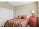 Inviting bedroom featuring Southwestern themed bedding and decor, a window with shutter and neutral colored walls at 16954 W Palm Ln, Goodyear, AZ 85395