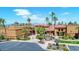 Beautiful community clubhouse surrounded by lush landscaping, trees, and ample parking at 16954 W Palm Ln, Goodyear, AZ 85395