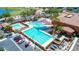 Inviting community pool area with covered seating, lush landscaping, and ample parking for residents and guests at 16954 W Palm Ln, Goodyear, AZ 85395