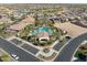 Aerial view of a luxurious community pool, surrounded by parking, lush palm trees, and well-maintained landscaping at 16954 W Palm Ln, Goodyear, AZ 85395