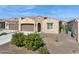 Charming single-story home with a two-car garage, manicured landscaping, and a neutral color palette at 16954 W Palm Ln, Goodyear, AZ 85395