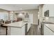 Spacious kitchen island with a sink, dishwasher, and seating in an open-concept living space at 16954 W Palm Ln, Goodyear, AZ 85395