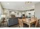 Open-concept living area featuring modern furnishings and neutral tones adjoining a bright, modern kitchen at 16954 W Palm Ln, Goodyear, AZ 85395