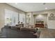 Comfortable living room featuring large windows with shutters, a gray sofa, and a southwest design aesthetic at 16954 W Palm Ln, Goodyear, AZ 85395