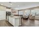 Open-concept living space featuring a modern kitchen with island seating and a cozy seating area at 16954 W Palm Ln, Goodyear, AZ 85395