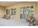 Covered patio featuring outdoor seating, smooth concrete flooring, and sliding glass doors for easy access at 16954 W Palm Ln, Goodyear, AZ 85395