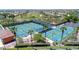 Aerial view of community pickleball courts surrounded by palm trees and lush landscaping at 16954 W Palm Ln, Goodyear, AZ 85395