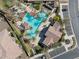 Aerial view of the resort-style community pool featuring palm trees and lounge areas at 16954 W Palm Ln, Goodyear, AZ 85395