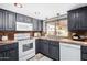 Modern kitchen with dark grey cabinets and white appliances at 17024 E Calle Del Sol --, Fountain Hills, AZ 85268