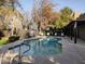 Inviting community pool with lounge chairs and trees at 1718 W Colter St # 170, Phoenix, AZ 85015