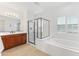 Large primary bathroom with soaking tub, glass enclosed shower, and and vanities at 17763 N 93Rd Way, Scottsdale, AZ 85255
