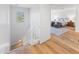 Hallway leading to a spacious bedroom with hardwood floors and a cozy sitting area at 17763 N 93Rd Way, Scottsdale, AZ 85255