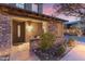 Inviting front entry with stonework and a charming covered porch at 17763 N 93Rd Way, Scottsdale, AZ 85255