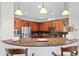 Well-lit kitchen with granite countertops, wood cabinets, stainless steel appliances and breakfast bar seating at 17763 N 93Rd Way, Scottsdale, AZ 85255