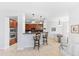 Modern kitchen with stainless steel appliances, bar seating, and view into the dining area at 17763 N 93Rd Way, Scottsdale, AZ 85255