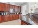 Cherry wood kitchen cabinetry, granite countertops and stainless sink at 17763 N 93Rd Way, Scottsdale, AZ 85255