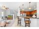 Bright open-concept living area leading to the kitchen with bar stool seating at 17763 N 93Rd Way, Scottsdale, AZ 85255