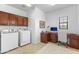 Dual-use laundry and office space with washer, dryer, and built in desk at 17763 N 93Rd Way, Scottsdale, AZ 85255