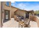 Enclosed patio features wicker seating and a glass table at 17763 N 93Rd Way, Scottsdale, AZ 85255